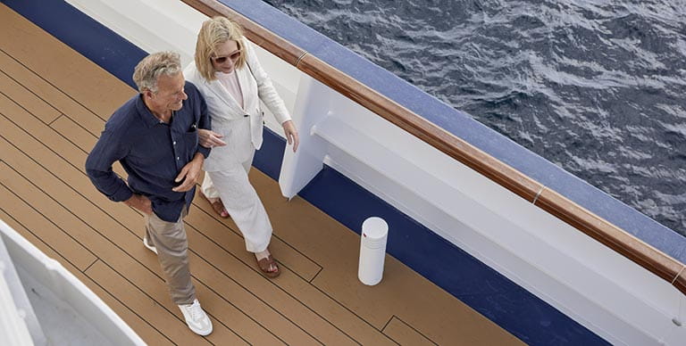 A couple walking along the Promenade Deck of Spirit of Adventure